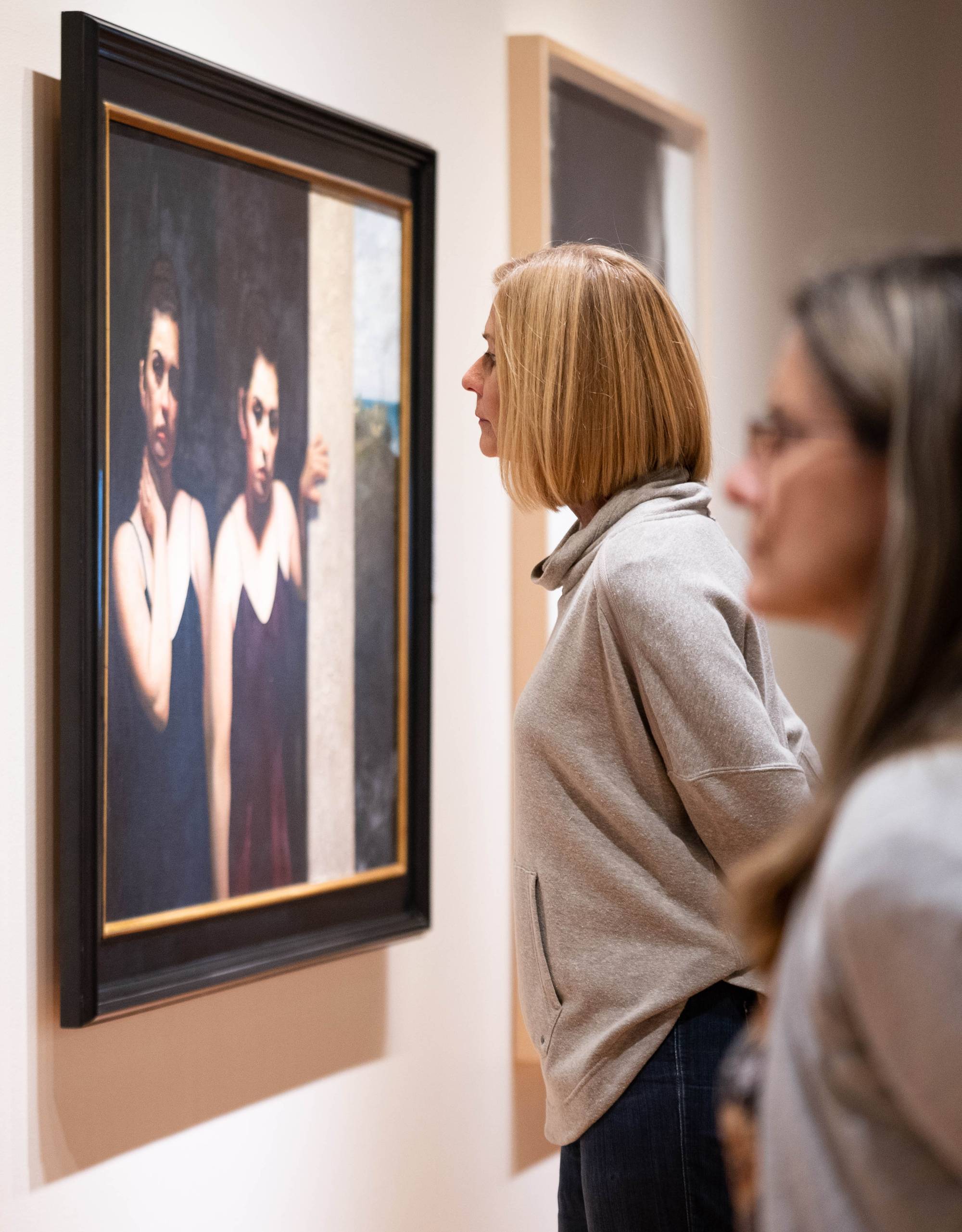 Visitors looking at artwork in the Gallery